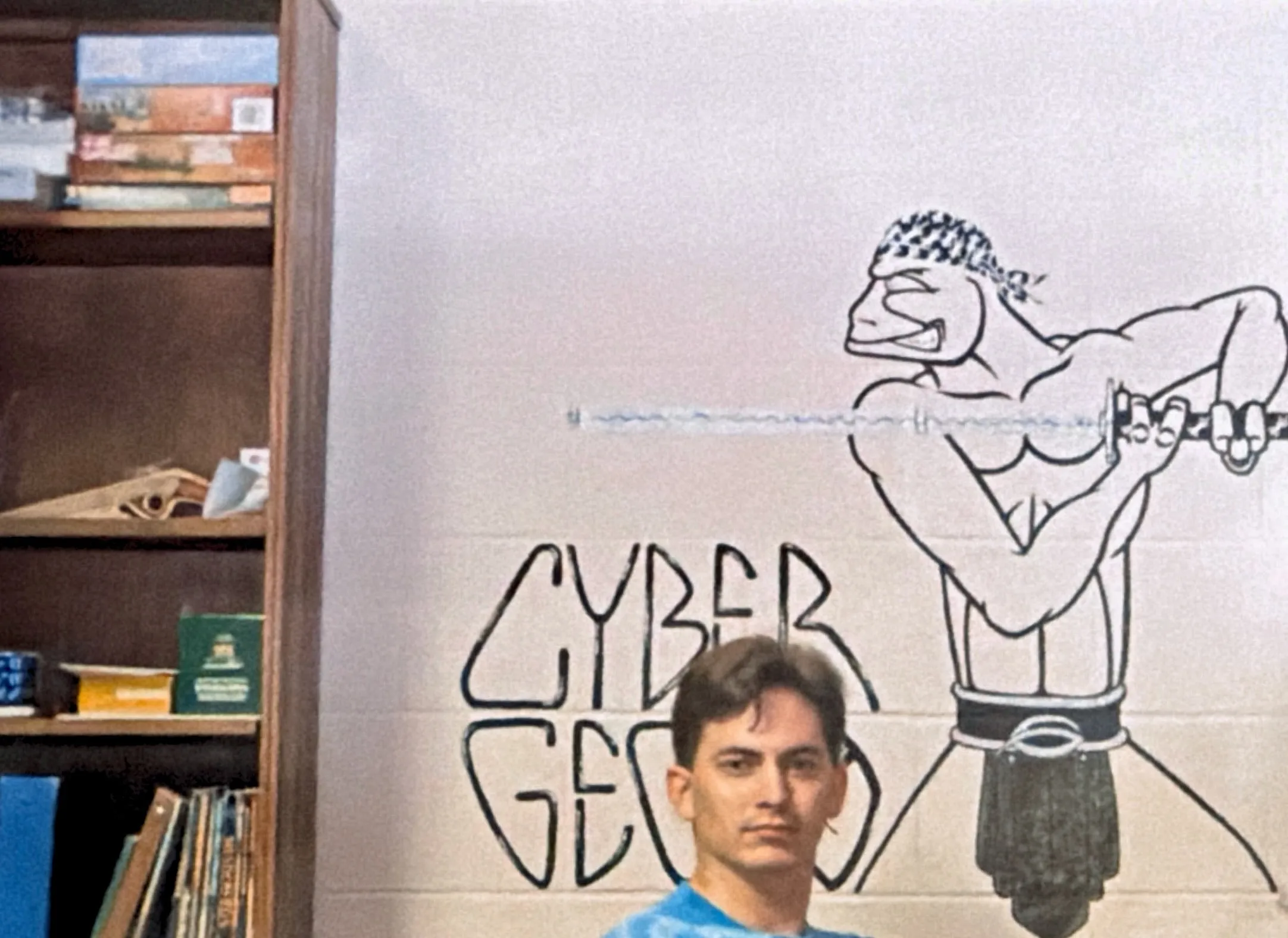 Chris in front of a dorm room mural