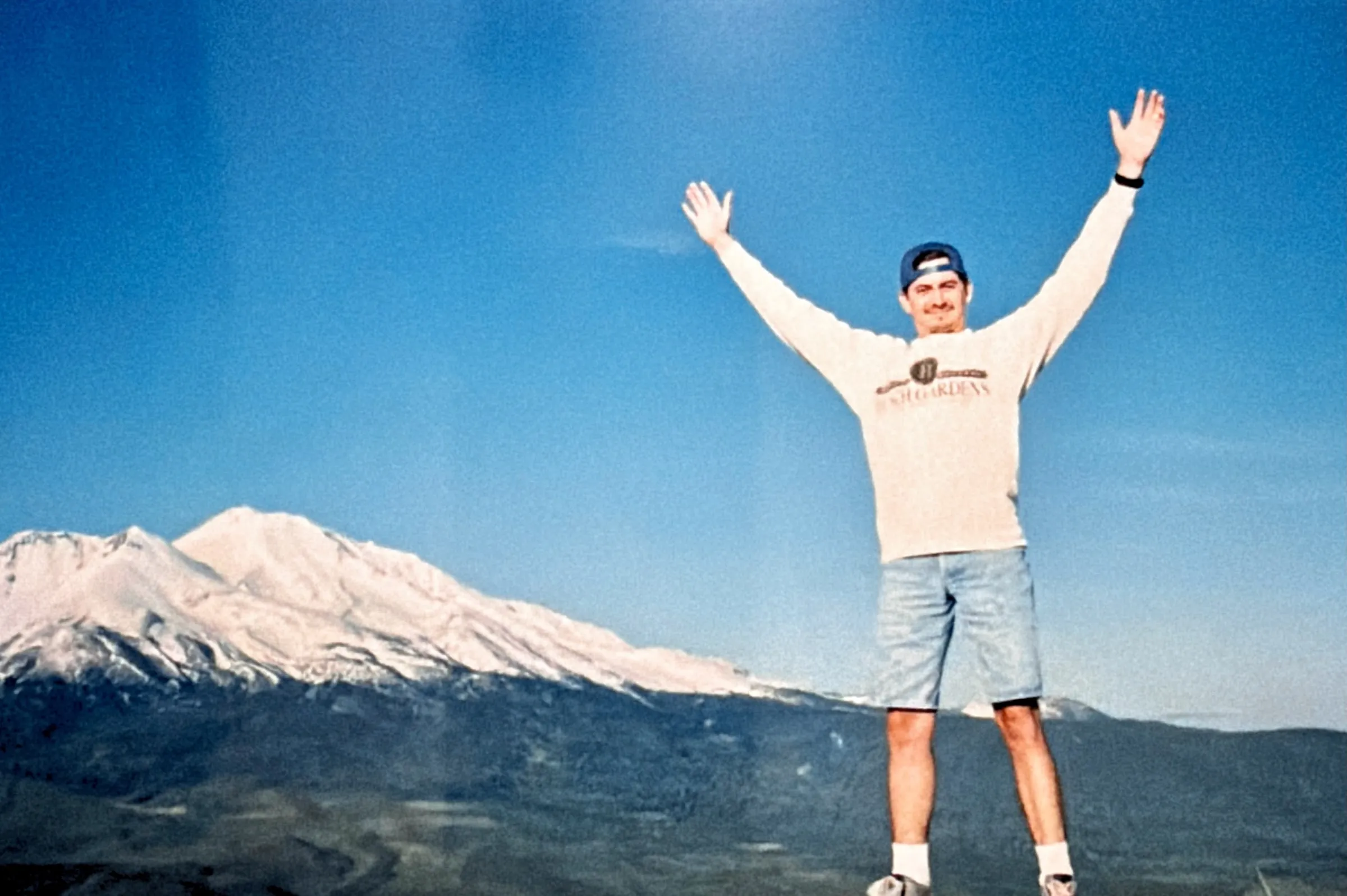 Chris standing on top of a mountain triumphantly