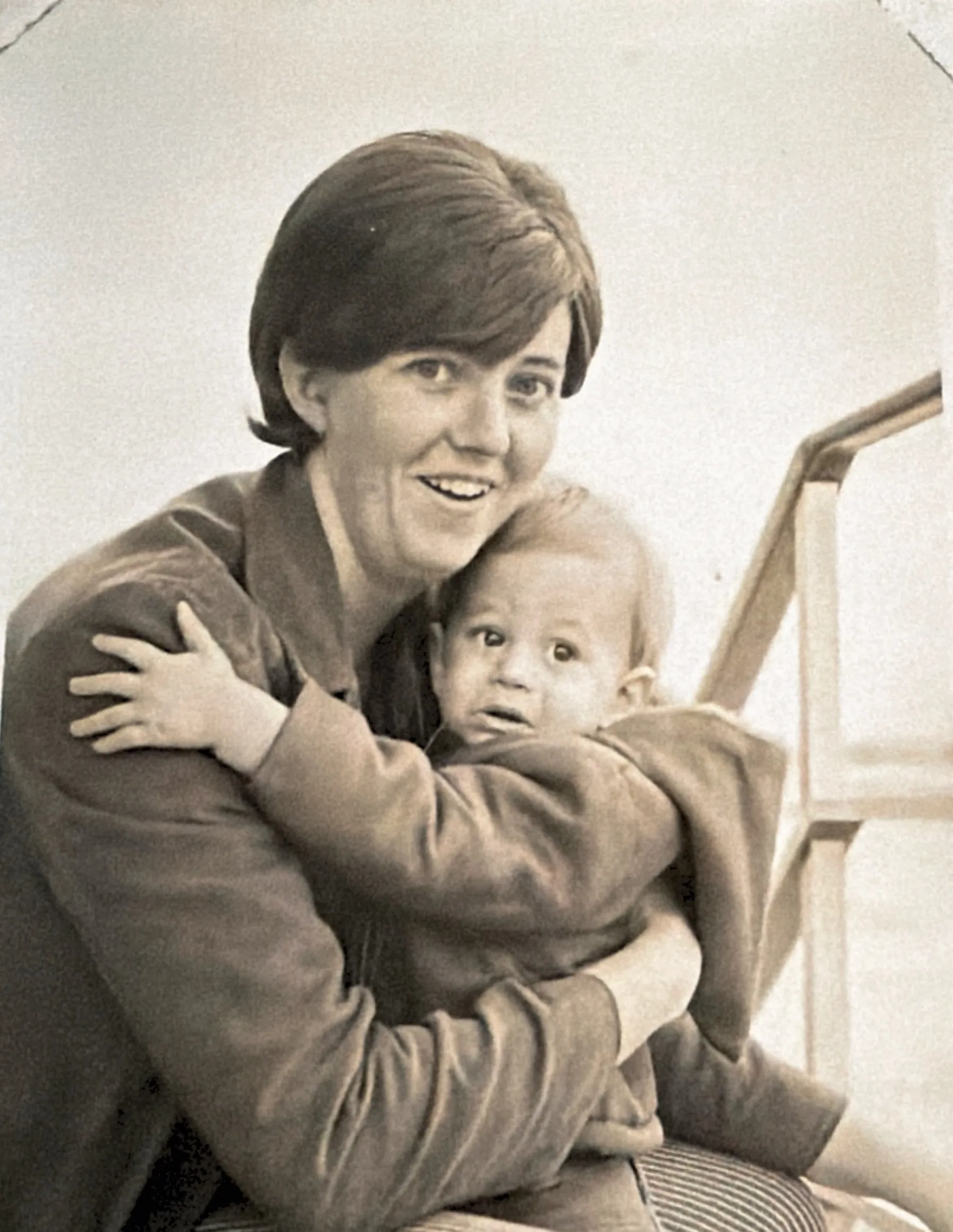 Chris as a baby clinging to his Mom